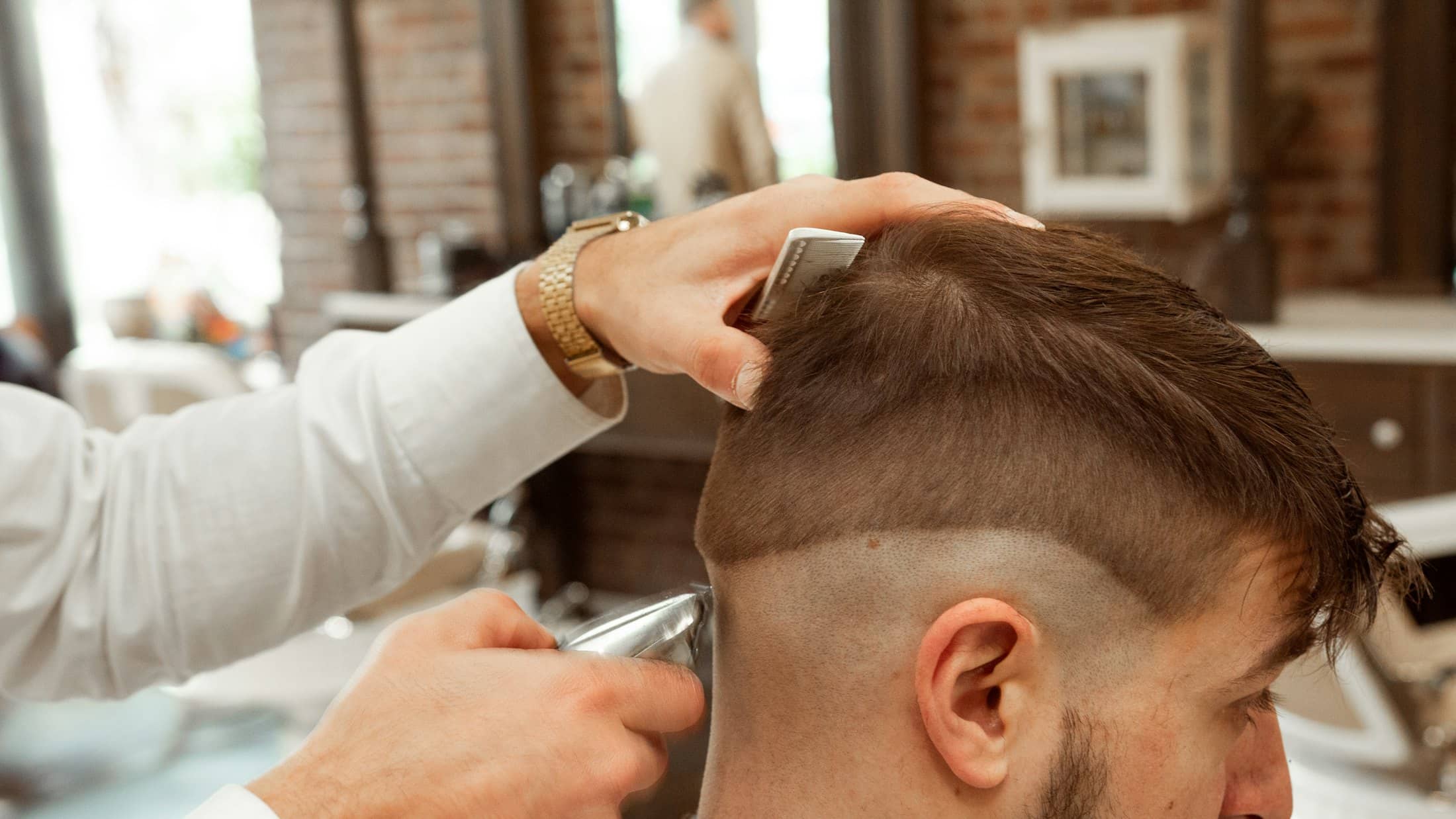 A stylist finishing a fade at Javi Hair Studio